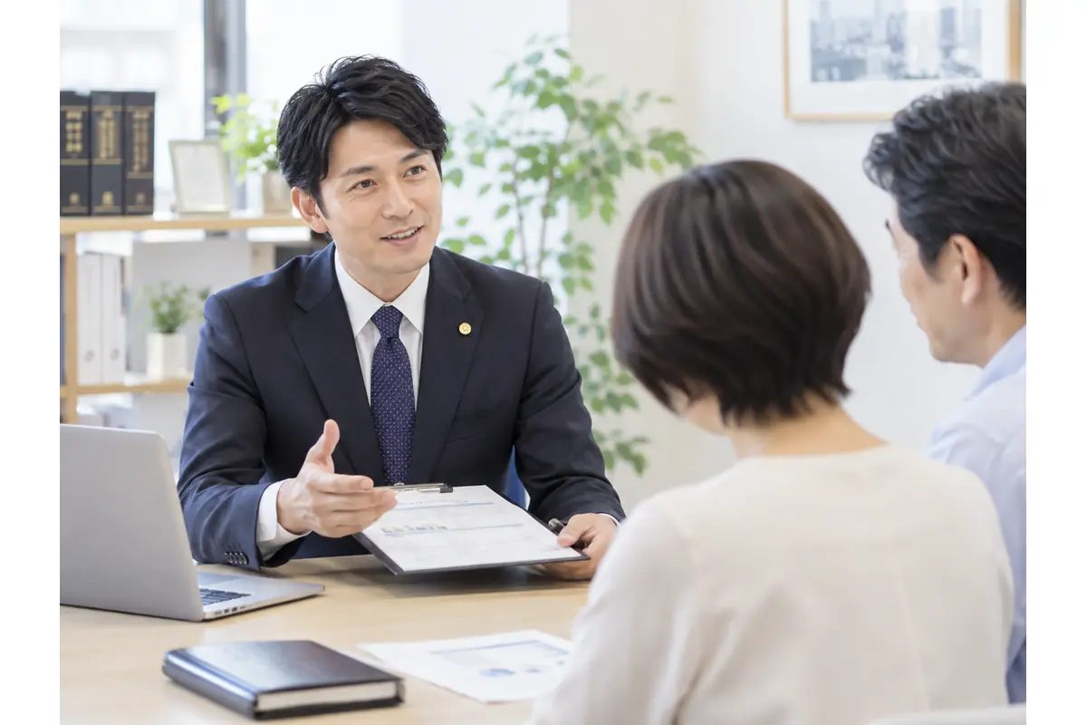 専門家が資料を示しながら、夫婦に相続の相談内容を説明しているイメージ